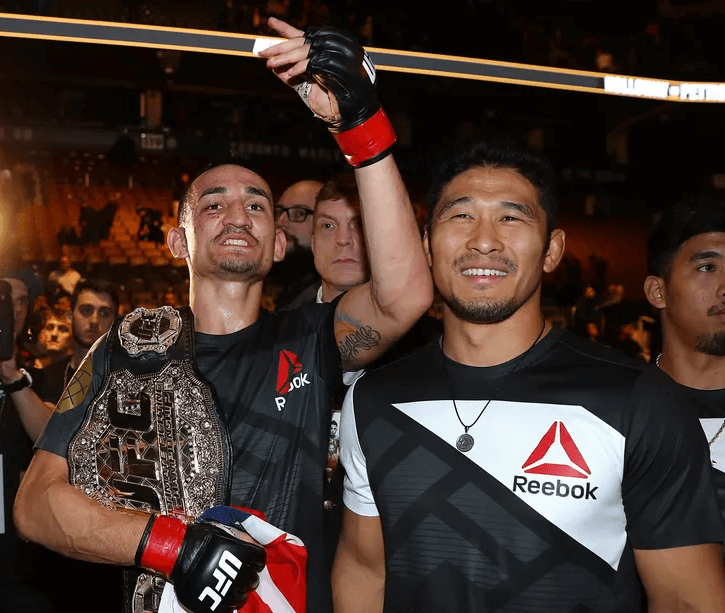 max holloway with unified featherweight belt